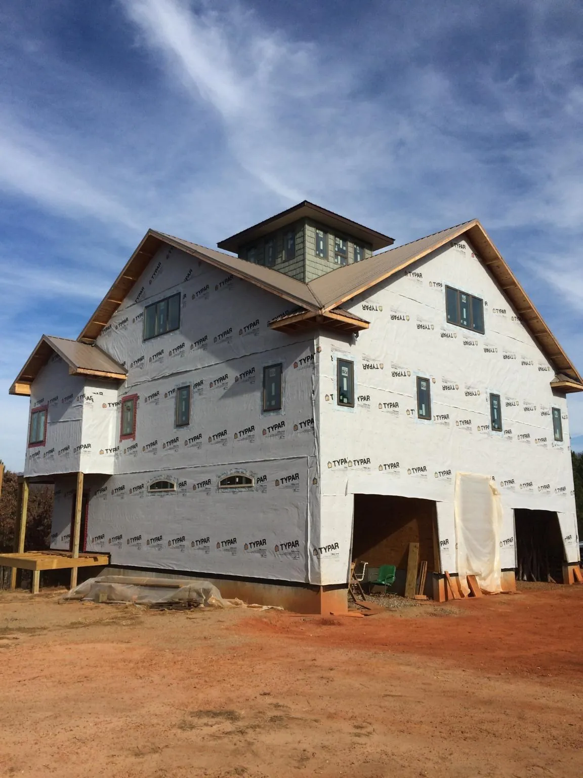 New two story house under construction with a cupola and gabled roofs in Crows Landing